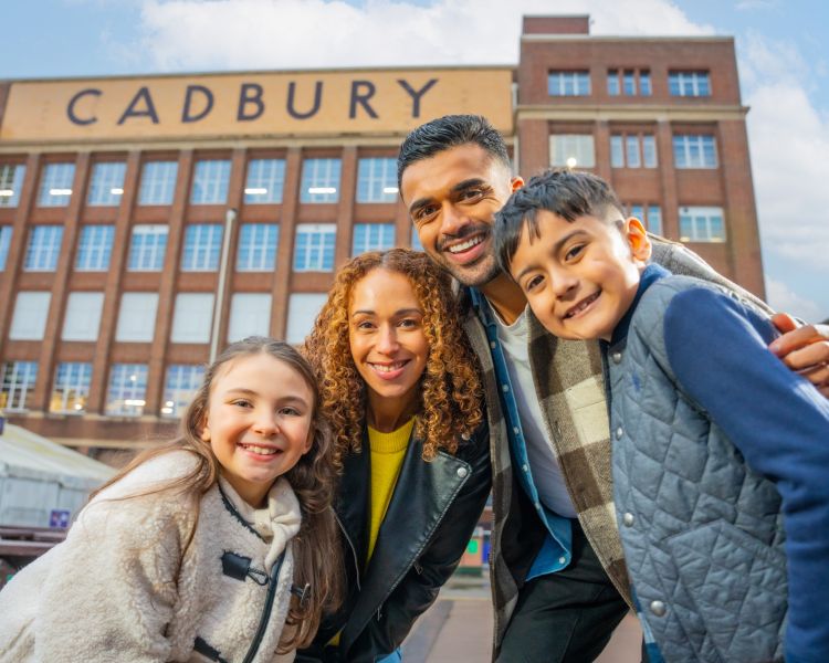 family photo outside cadbury world building