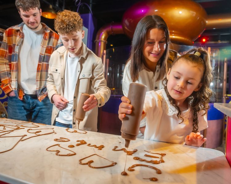 family doing chocolate doodles at cadbury world in birmingham