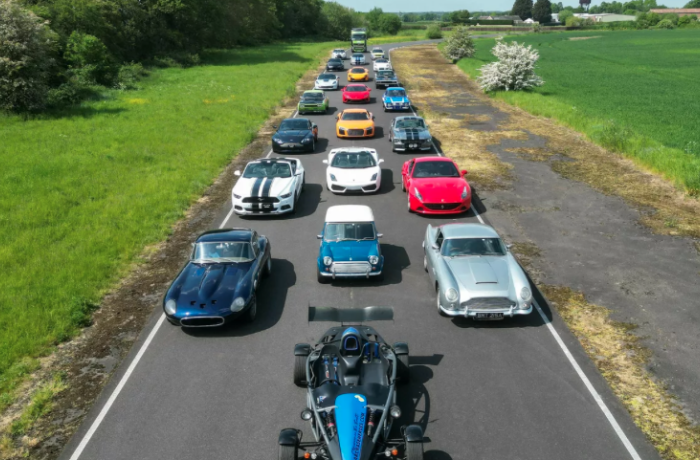 sports cars and classic cars lined up on a road to show things to do in Wigan like driving experience days