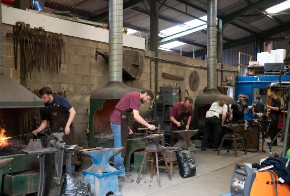 participants on a blacksmith experience in suffolk