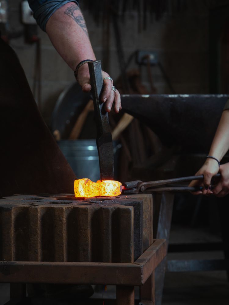 axe head being forged on blacksmith experience in suffolk