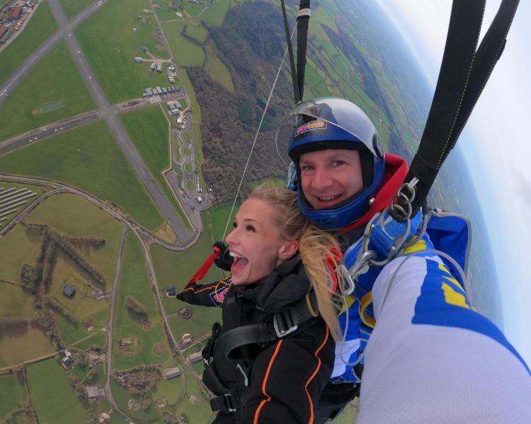 woman on tandem skydive over devon countryside