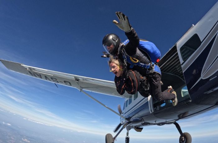 tandem skydivers jumping out of plane