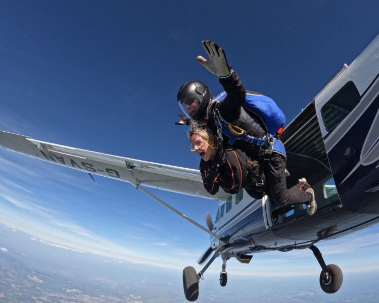 tandem skydivers jumping out of plane