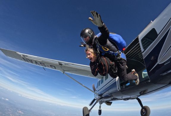 tandem skydivers jumping out of plane