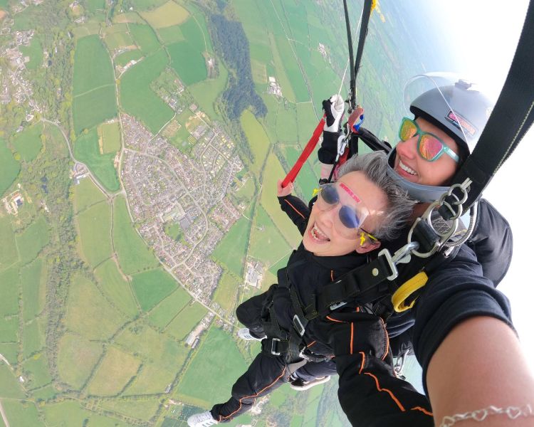 woman on tandem skydive over devon countryside