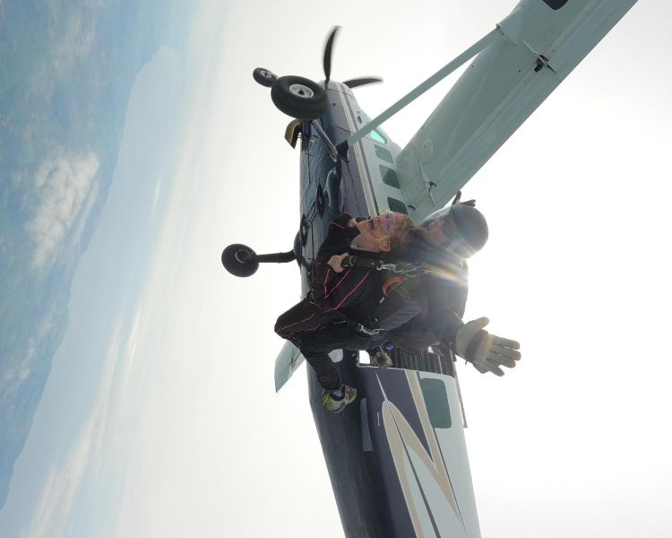 tandem skydivers jumping out of plane