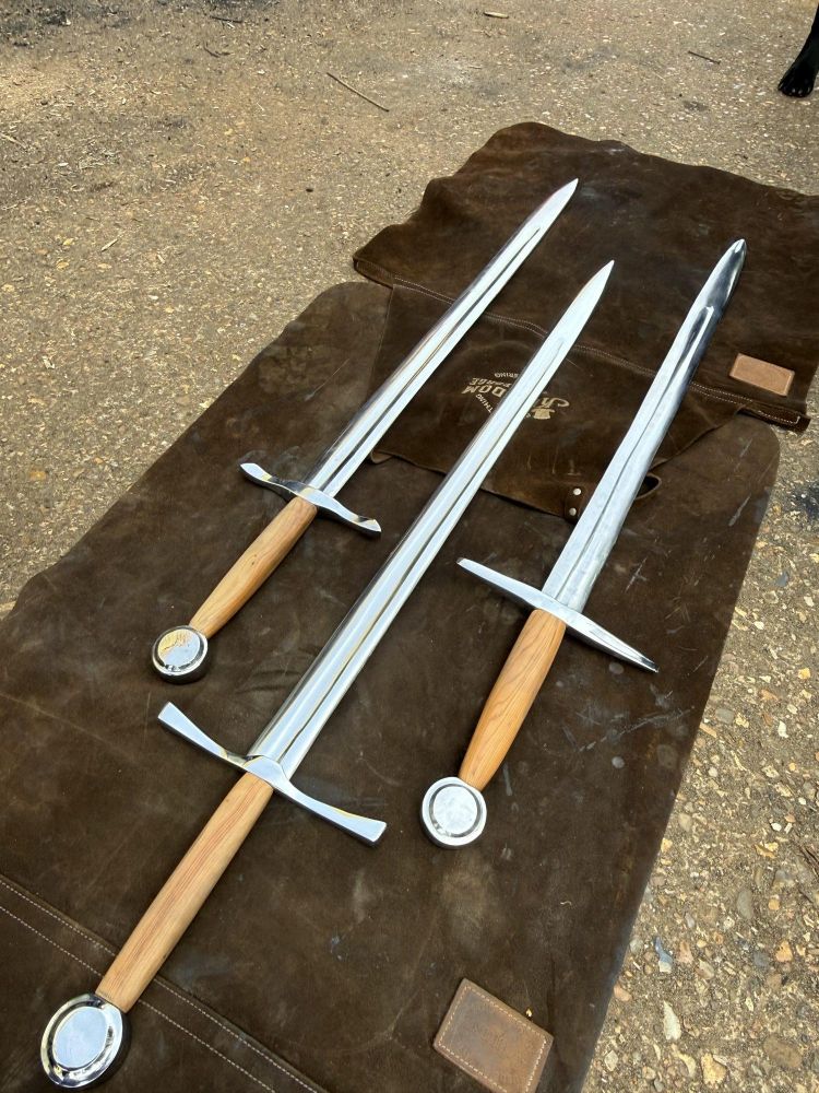 swords laid on floor as examples of what can be made on a sword making experience