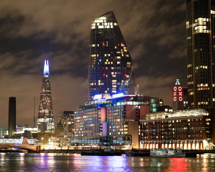 london lit up at night seen from uber boat illuminated river tour