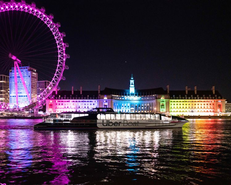 london eye lit up in pink seen on uber boat tour for illuminated river art installation