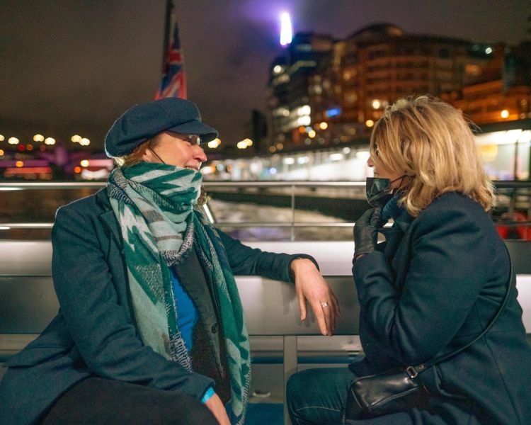 ladies talking on uber boat tour for illuminated river art installation