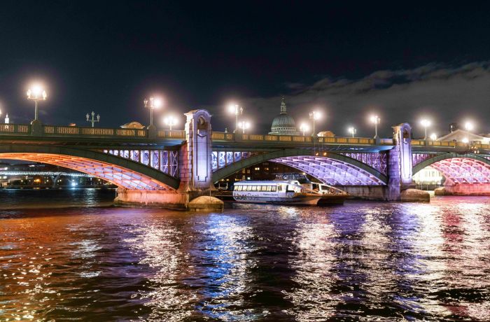 uber boat going under bridge lit up for illuminated river art installation