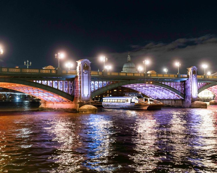 uber boat going under bridge lit up for illuminated river art installation