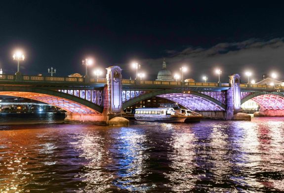 uber boat going under bridge lit up for illuminated river art installation