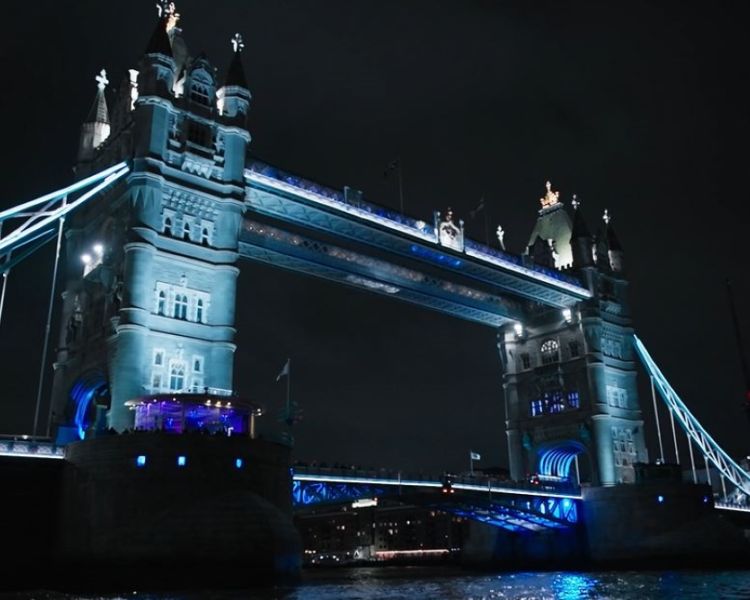 tower bridge lit up for illuminated river art installation seen on uber boat cruise
