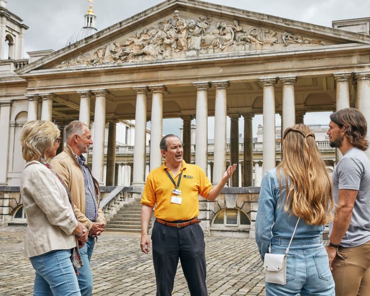 a guide talking to tour group at old royal naval college in london
