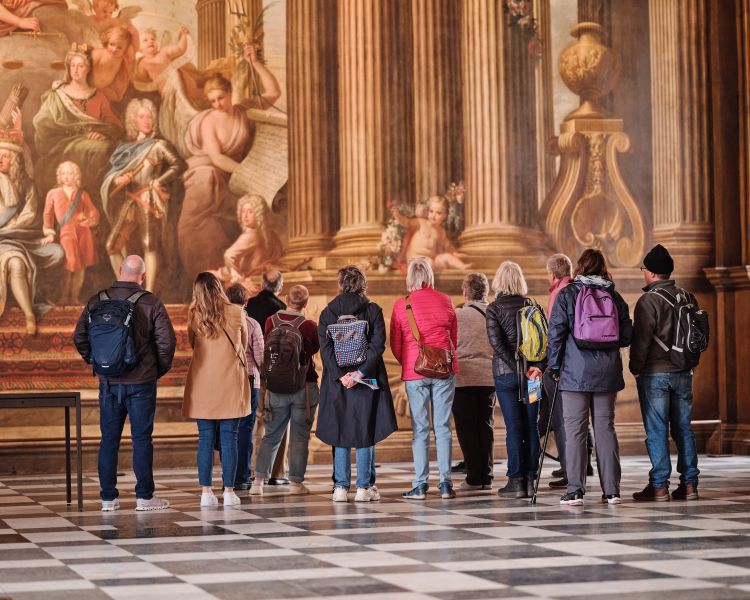 guided tour group in painted hall at old royal naval college in london