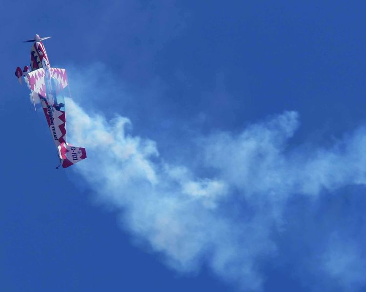 plane doing an aerobatic manoeuvre in the sky
