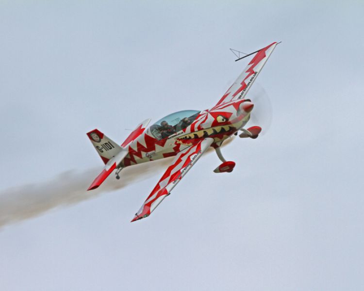 plane doing an aerobatic manoeuvre in the sky