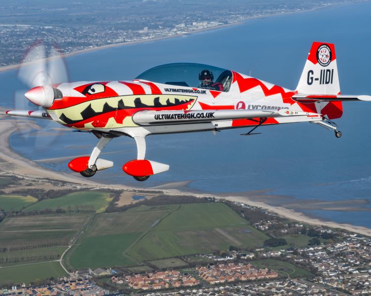 red and white plane flying over south coast