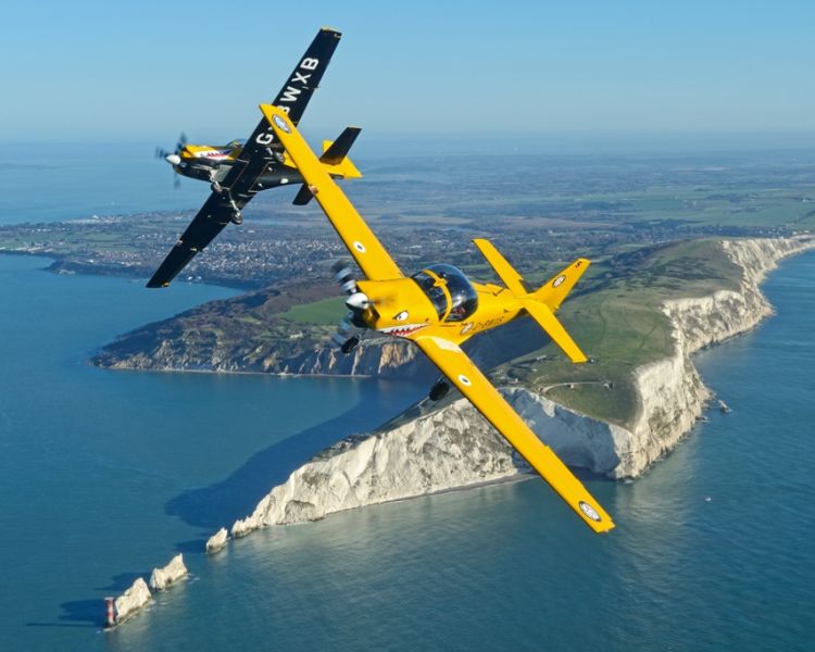 top gun plane formation soaring over cliffs on top gun flying experience