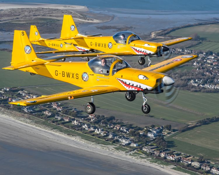 two yellow planes flying side by side on top gun flying experience