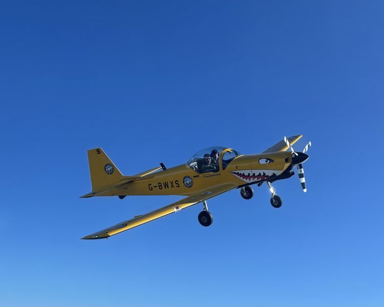 yellow plane against blue sky on fighter pilot flying experience