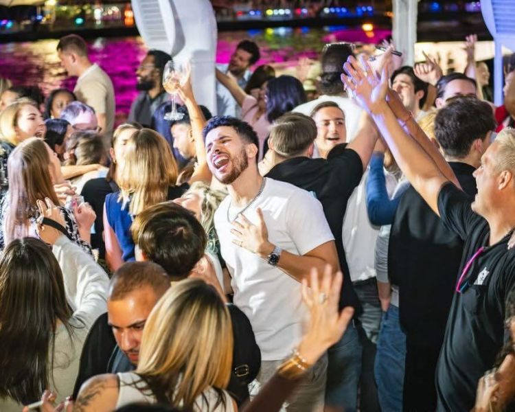 people dancing in the nightclub on the top deck of the tattershall castle boat in london
