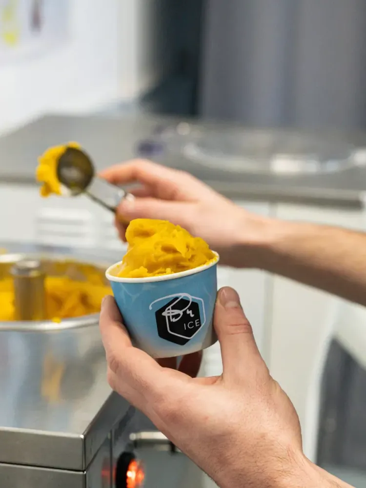 gelato being scooped into a tub on a learn how to make gelato workshop in london