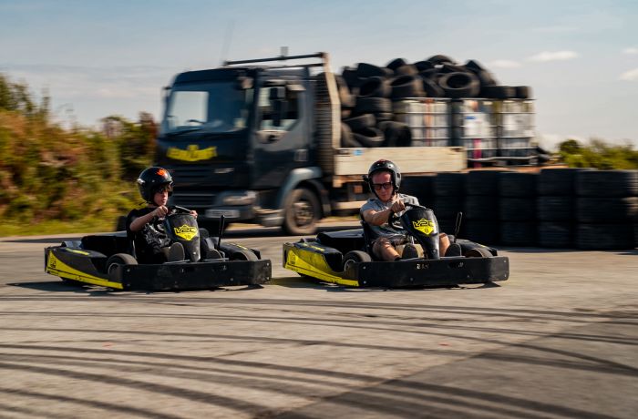 man and boy on drift karting experience going around track