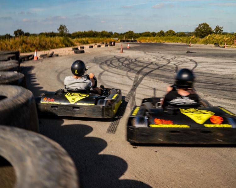 man and boy on drift karting experience going around track