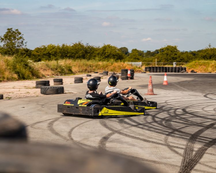 man and boy on drift karting experience going around track