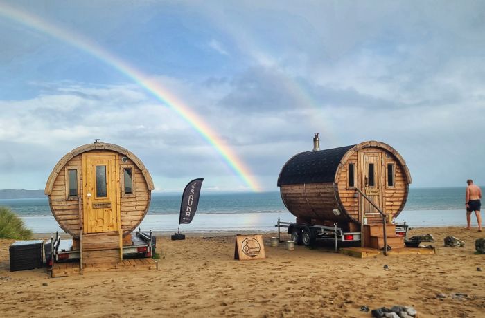 two sauna pods on the beach in wales