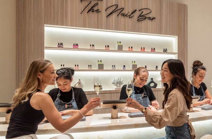 ladies at townhouse nail bar having nails done and drinking champagne