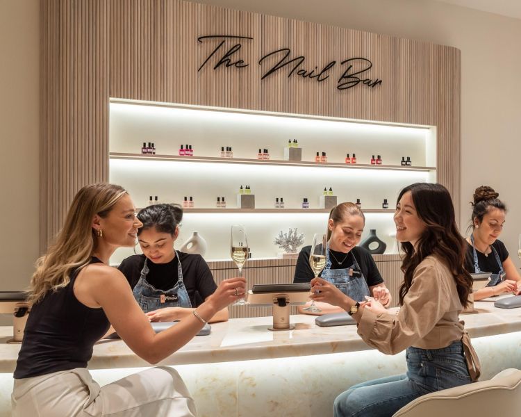 ladies at townhouse nail bar having nails done and drinking champagne