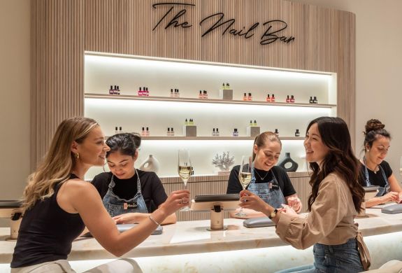 ladies at townhouse nail bar having nails done and drinking champagne