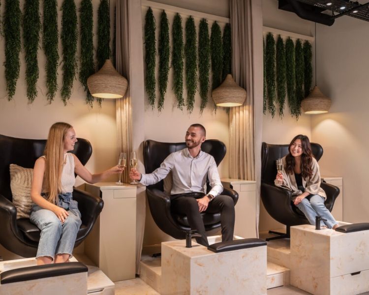 two ladies and man having pedicures at townhouse nail salon