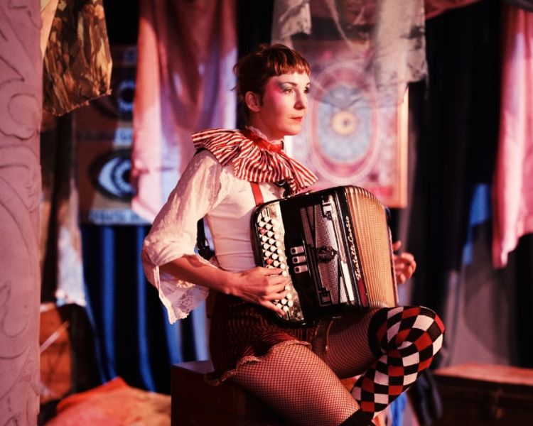 Accordion player at the magicians table immersive show london