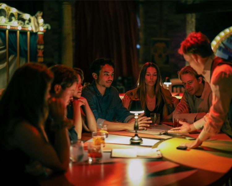 Guests watching magician at vip seating at the magicians table immersive show