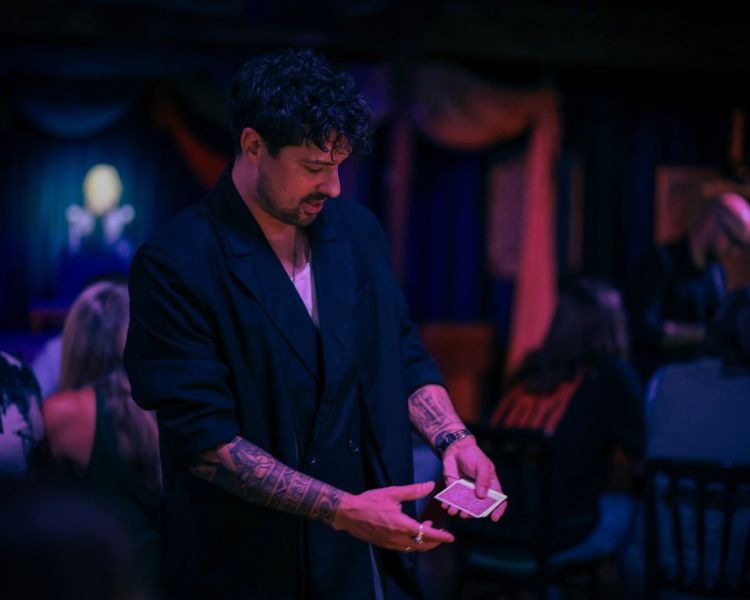 Magician doing card trick at the magicians table show london