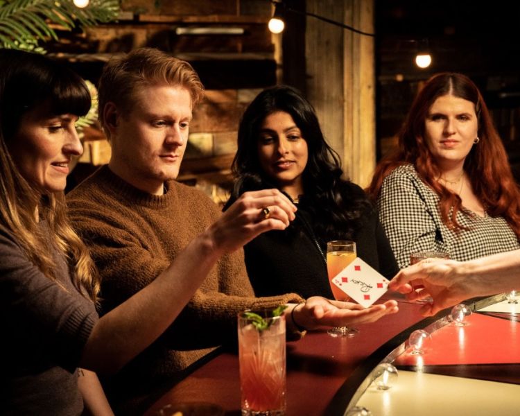 Guests at vip seating at the magicians table immersive show