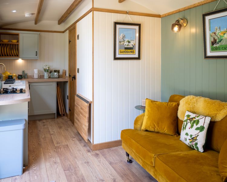 interior living space of ensuite shepherd hut at glamping site in dorset