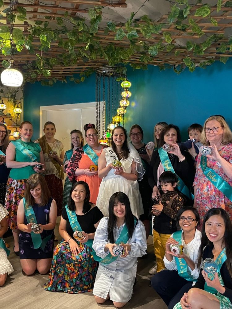 Hen party group holding their mosaic candle holders