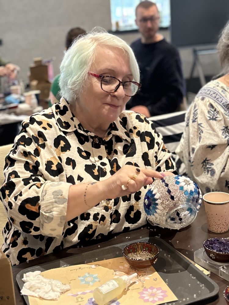 Lady making mosaic candle holder