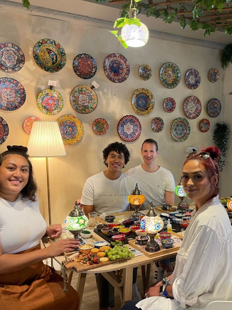 People at turksish mosaic lamp decorating workshop