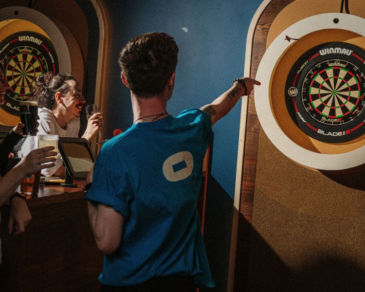 people playing darts at the lucky goat in london