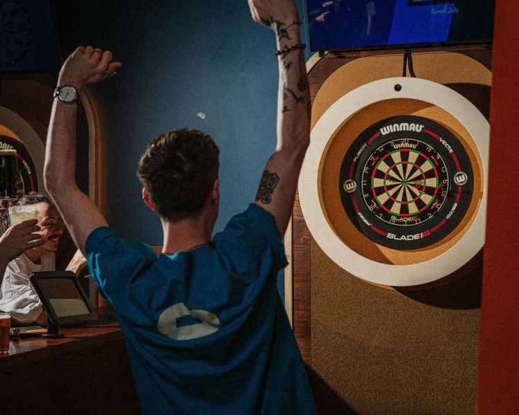 people playing darts at the lucky goat in london