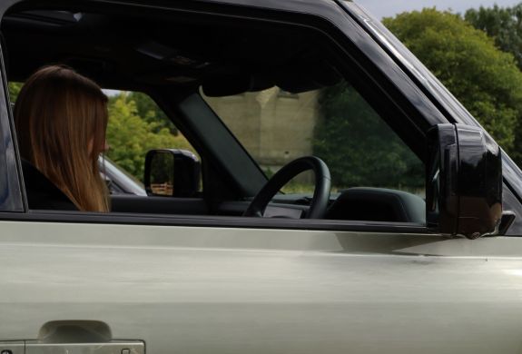 Junior driver in land rover defender