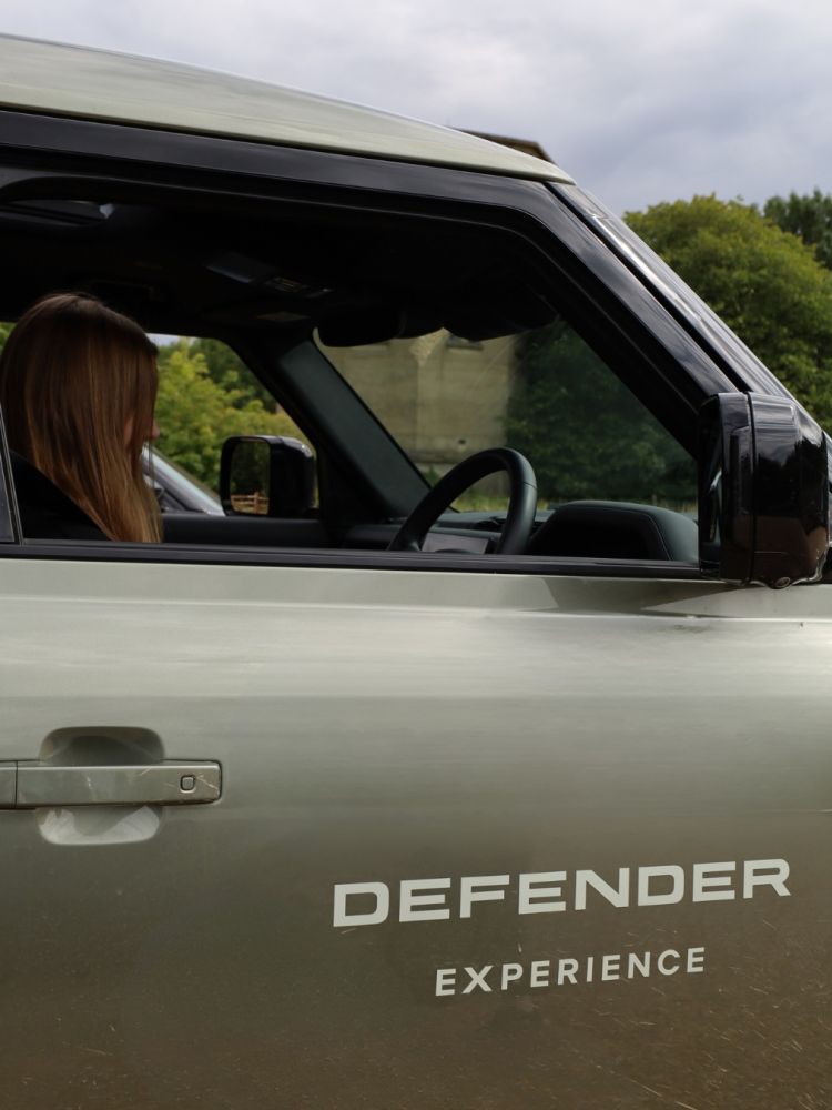 Junior driver in land rover defender