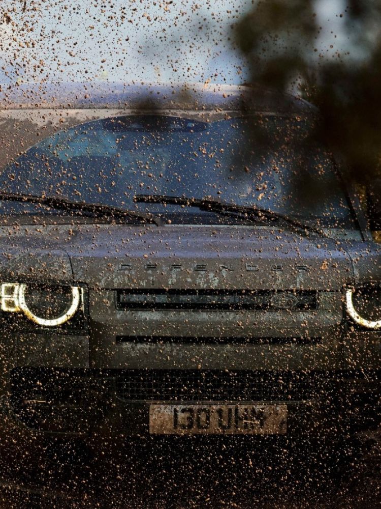 Land rover defender in muddy water on driving experience